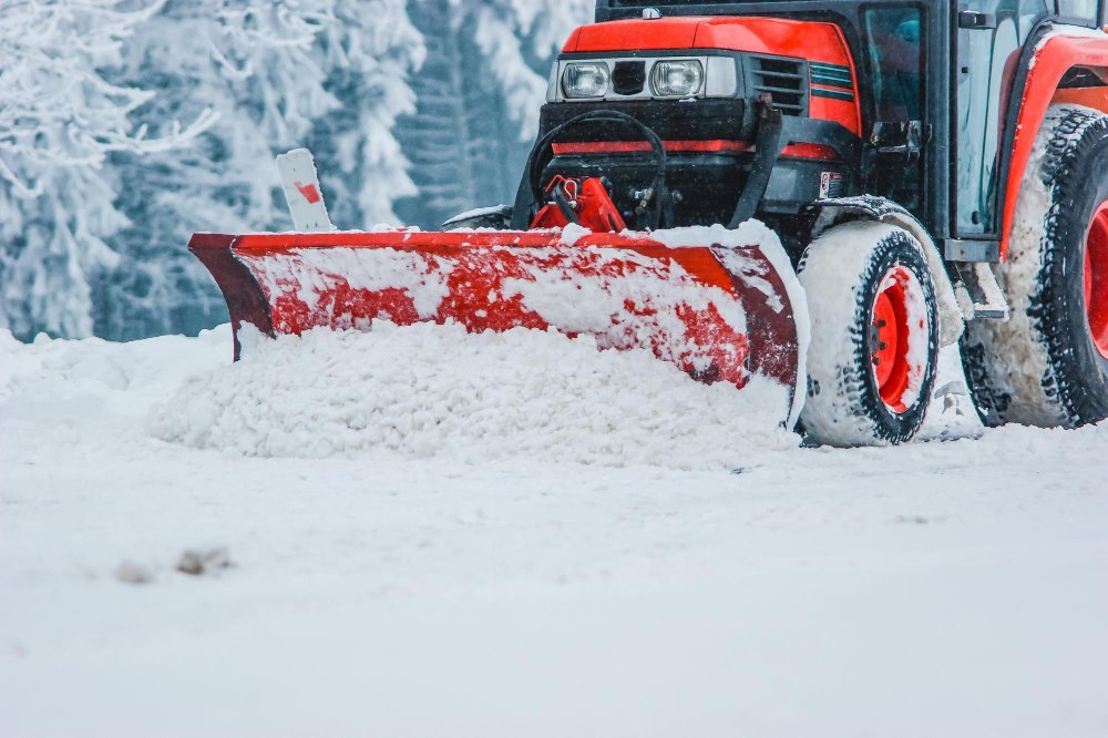 Snow plow clearing winter conditions